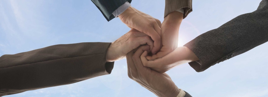 Business people holding hands in circle