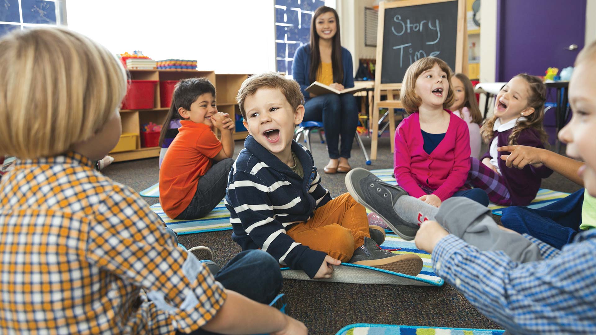 children sitting in classroom and laughing