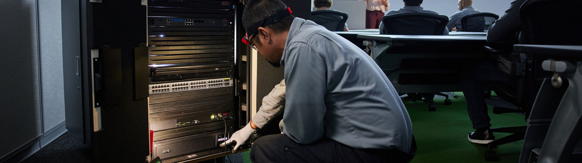 Image of Field Service Rep working on Micro Data Center in an auditorium-like setup