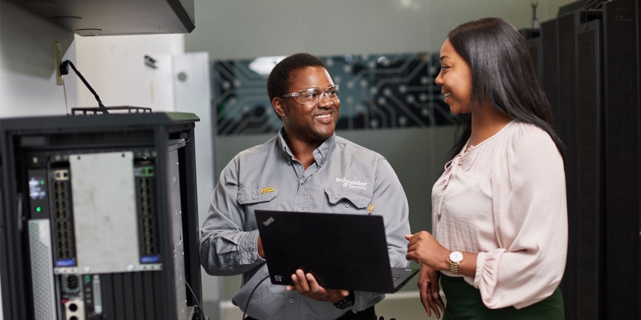 Image of Field Service Rep and/or clients working on Micro Data Center on wall