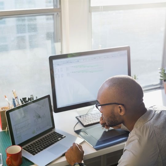 Business people working on laptop in office