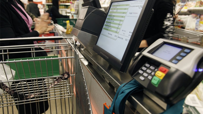 A person at the cash register of a supermarket