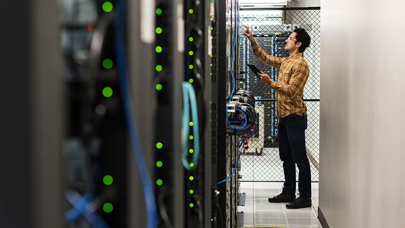 Technician working in computer server room