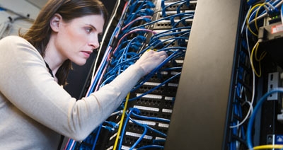 Female IT support technician repairing server