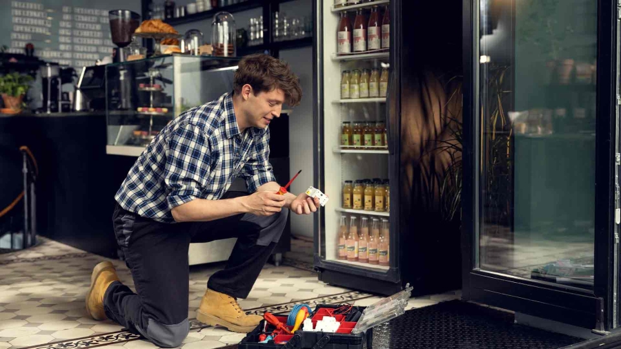 Man repairs the machinery with tools