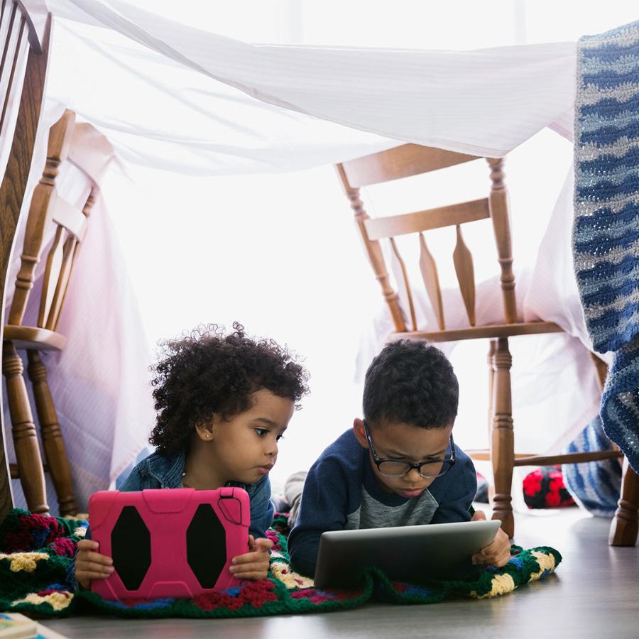 Child playing on tablet on floor