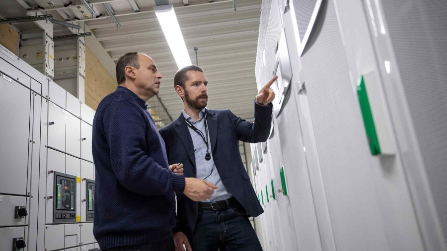 Two male employees discussing at a data