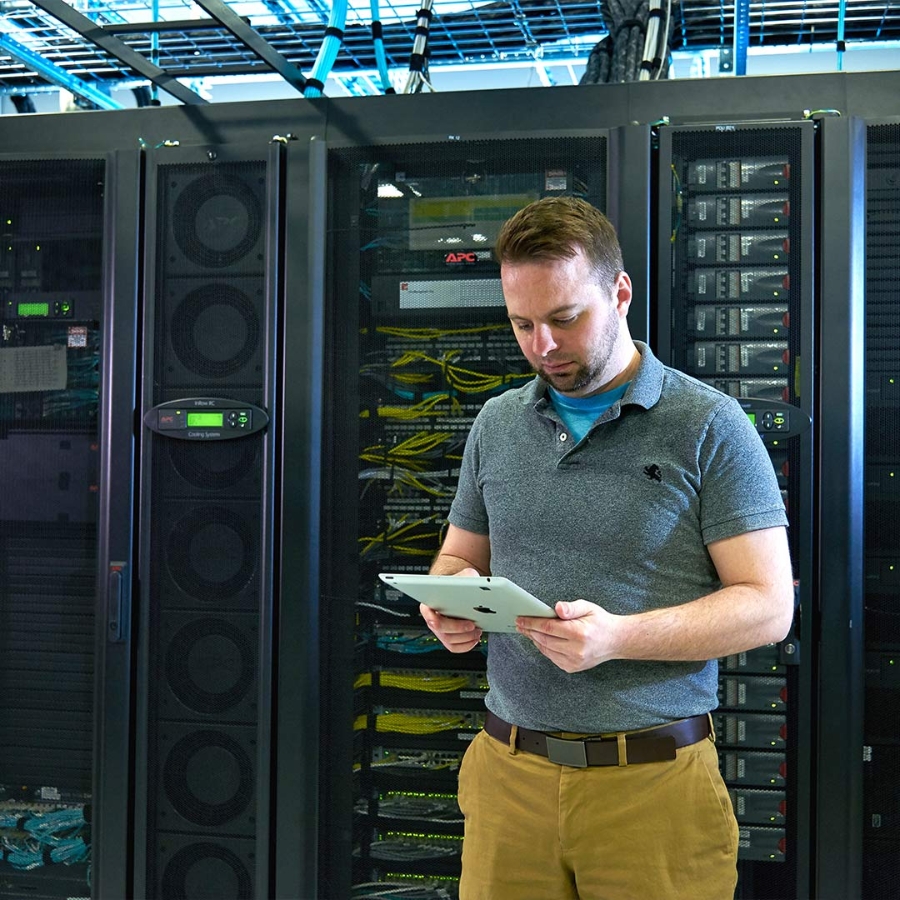 man with tablet working in data center