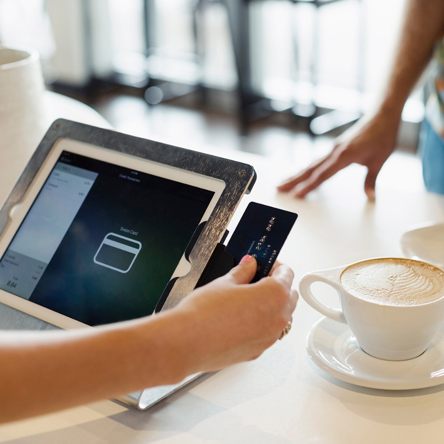 A person working on laptop having cup of coffee